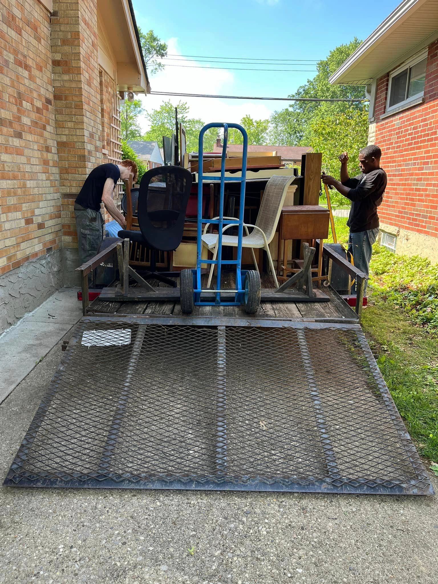 Do Good Cleanouts team loading furniture at a residential property